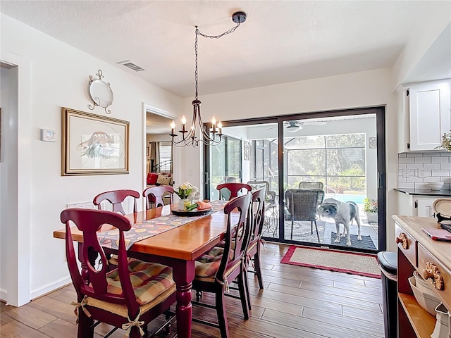 4806 SW County Road 769, Arcadia, FL 34269 - dining space with visible vents, baseboards, wood finished floors, and a notable chandelier