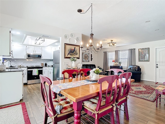 4806 SW County Road 769, Arcadia, FL 34269 - dining room with a notable chandelier, visible vents, and light wood-style floors