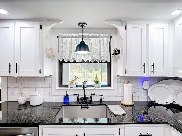 4806 SW County Road 769, Arcadia, FL 34269 - kitchen with a sink, white cabinetry, dark stone countertops, and decorative light fixtures
