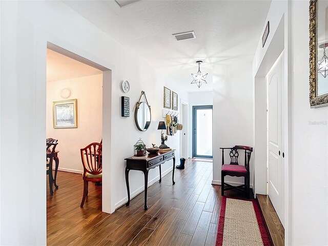 4806 SW County Road 769, Arcadia, FL 34269 - hall featuring visible vents, baseboards, a notable chandelier, and dark wood-style floors