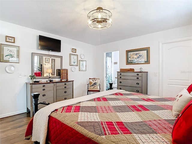 4806 SW County Road 769, Arcadia, FL 34269 - bedroom with an inviting chandelier, baseboards, and wood finished floors