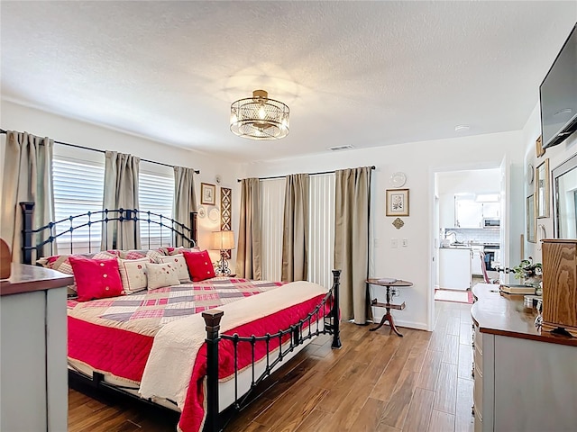4806 SW County Road 769, Arcadia, FL 34269 - bedroom featuring visible vents, a textured ceiling, and wood finished floors