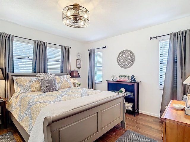 4806 SW County Road 769, Arcadia, FL 34269 - bedroom featuring an inviting chandelier, baseboards, and dark wood-style floors