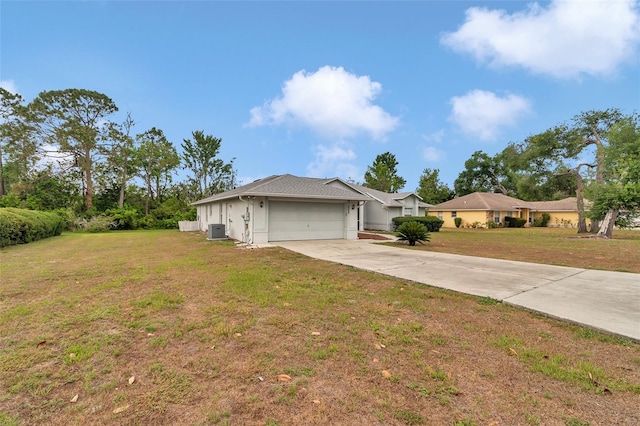 single story home with an attached garage, concrete driveway, a front lawn, stucco siding, and central AC unit