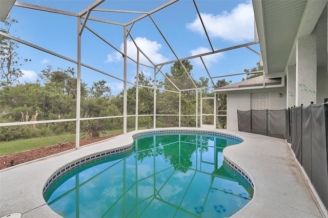 outdoor pool with a lanai and a patio area