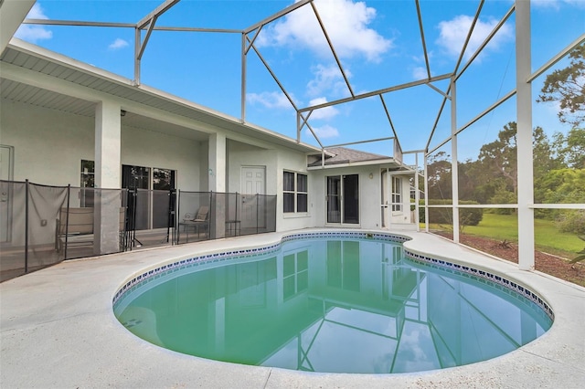 swimming pool with a lanai and a patio area
