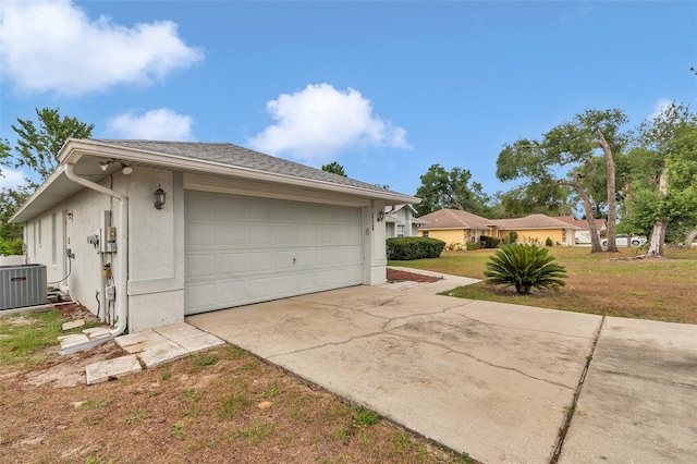 garage featuring cooling unit and concrete driveway