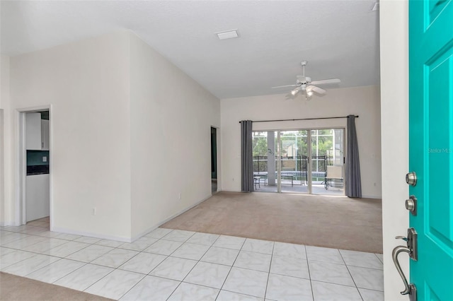 entryway featuring light carpet and ceiling fan