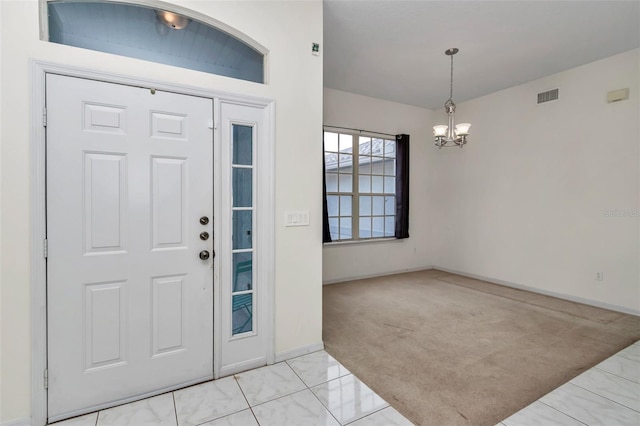 entryway featuring a chandelier, baseboards, and light carpet