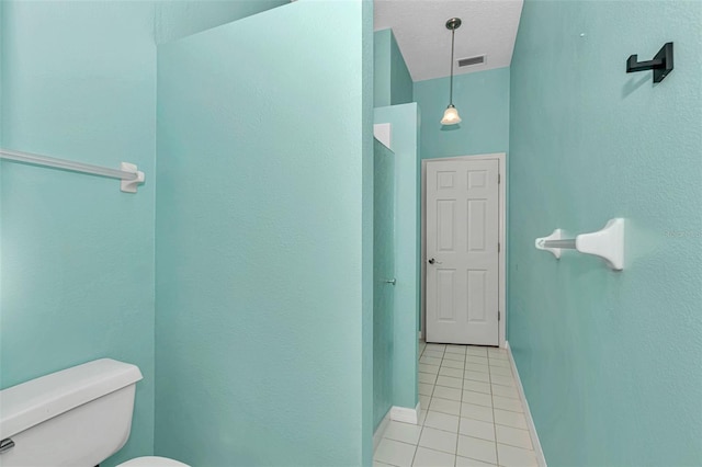 bathroom featuring tile patterned floors, toilet, and baseboards