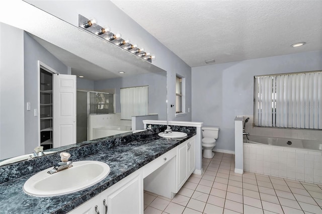 bathroom with tile patterned floors, a stall shower, baseboards, a garden tub, and toilet