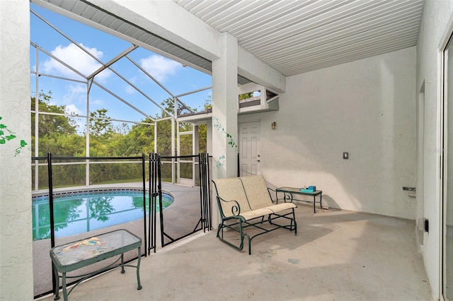 view of patio with an outdoor pool and a lanai