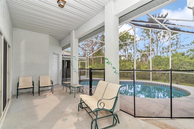 outdoor pool with a patio area and a lanai