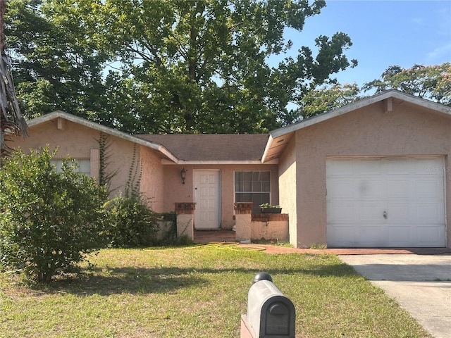single story home featuring a front yard, stucco siding, a garage, and driveway