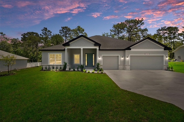 view of front facade with driveway, a front lawn, and a garage