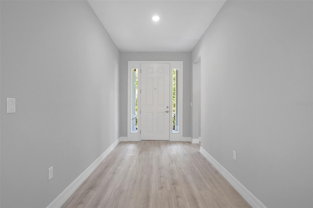 entrance foyer featuring baseboards, recessed lighting, and light wood-style flooring
