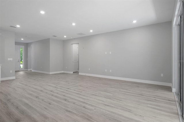 empty room with light wood-style floors, baseboards, recessed lighting, and visible vents