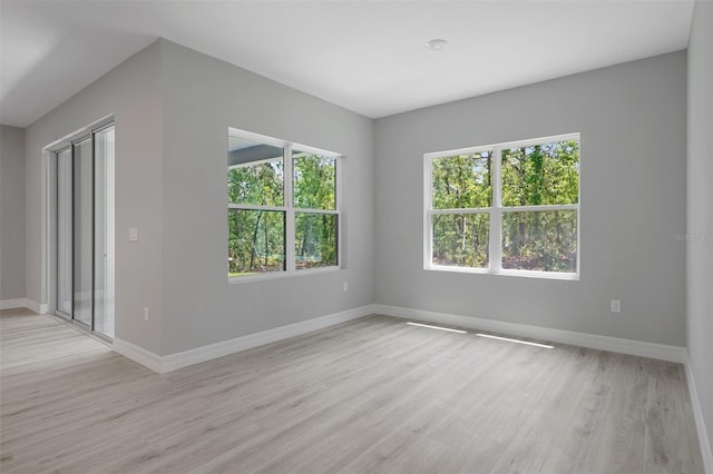 unfurnished room featuring light wood-style floors and baseboards