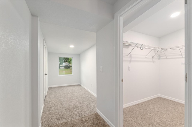 hall with baseboards, carpet flooring, and recessed lighting