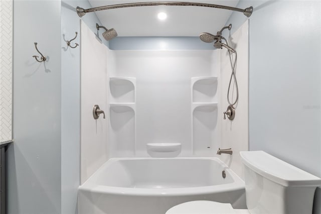 bathroom with shower / bathtub combination and toilet