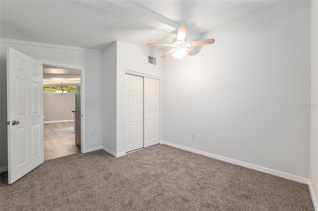 unfurnished bedroom featuring baseboards, visible vents, a closet, ceiling fan, and carpet floors