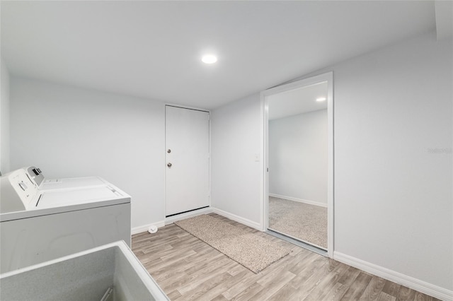 laundry area with washing machine and clothes dryer, light wood-style floors, baseboards, laundry area, and recessed lighting