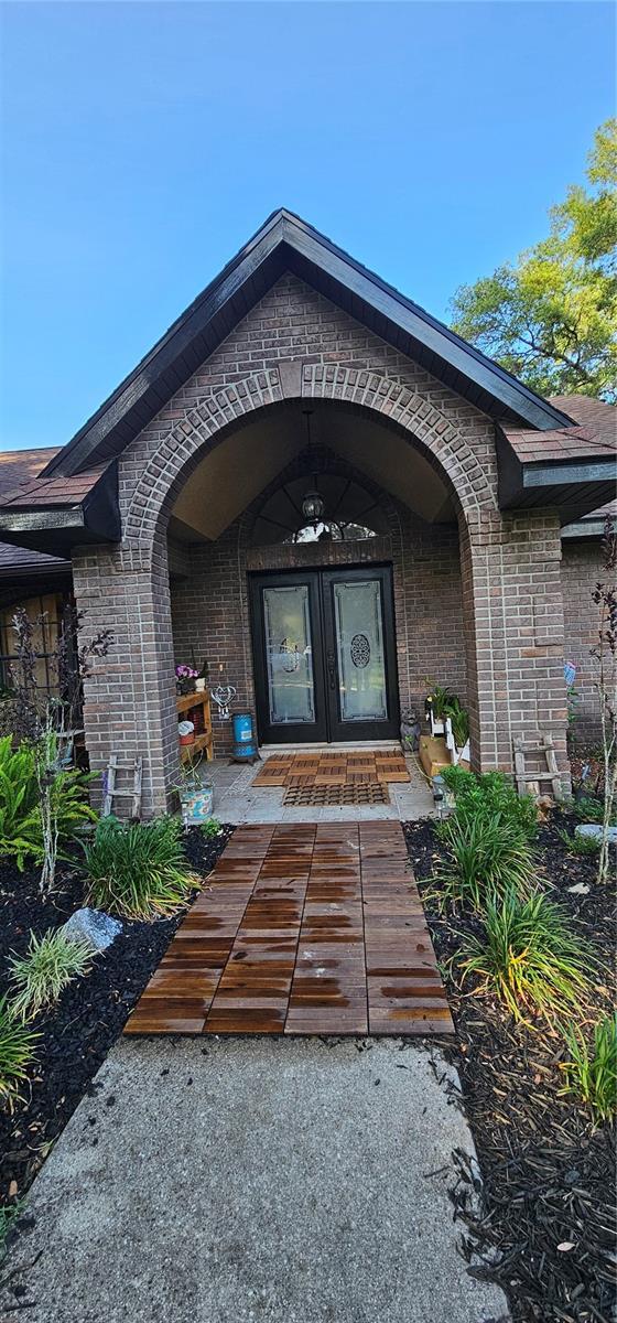 property entrance featuring brick siding