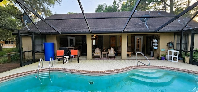 exterior space with a wooden deck, a patio, and glass enclosure