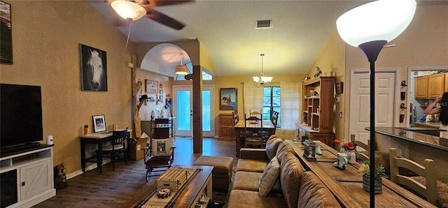 living area featuring baseboards, arched walkways, ceiling fan with notable chandelier, dark wood-style floors, and visible vents