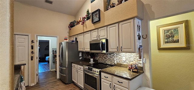 kitchen with tasteful backsplash, visible vents, a textured wall, appliances with stainless steel finishes, and dark wood finished floors