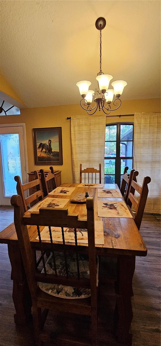 dining room featuring wood finished floors and a notable chandelier
