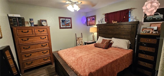 bedroom with ceiling fan and dark wood-type flooring