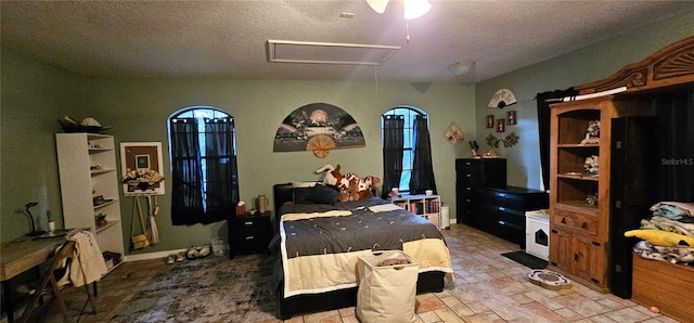 bedroom with attic access and a textured ceiling