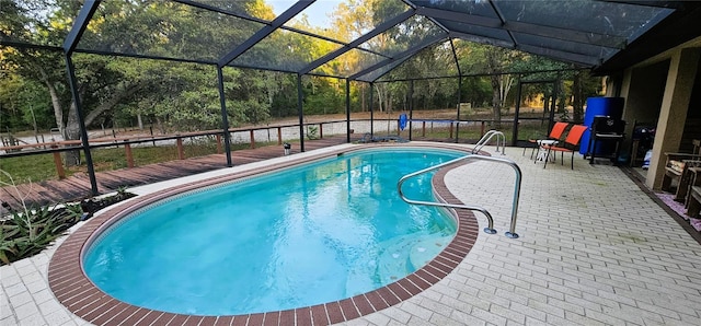 outdoor pool featuring a lanai and a patio area