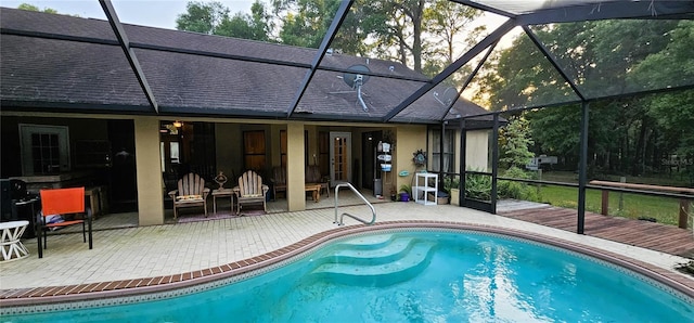 outdoor pool featuring a deck, a patio area, and a lanai