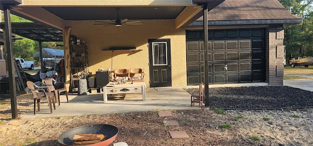 exterior space with ceiling fan and stucco siding