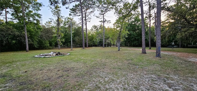 view of yard with an outdoor fire pit