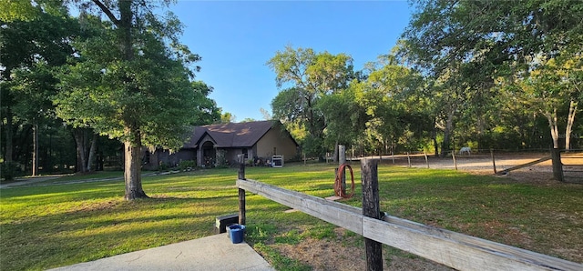 view of home's community featuring fence and a yard