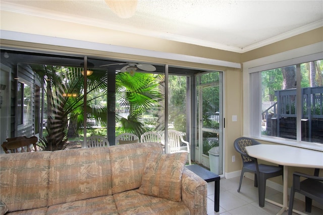 sunroom with ornamental molding, tile patterned floors, and baseboards