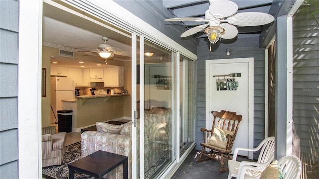 sunroom / solarium with visible vents and ceiling fan