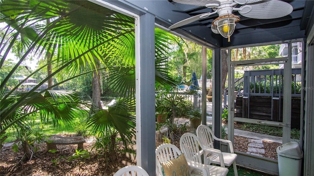 sunroom / solarium with a ceiling fan