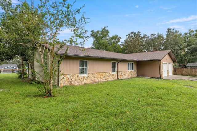 1081 SE 170th Ave, Silver Springs, FL 34488 - view of front facade with stone siding, a garage, and driveway