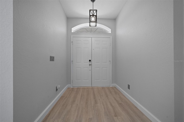 entrance foyer featuring baseboards and light wood-style floors