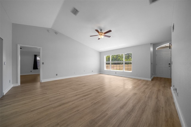 unfurnished living room with light wood-style flooring, vaulted ceiling, baseboards, visible vents, and a ceiling fan