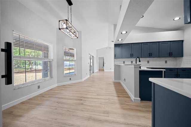 kitchen with light countertops, recessed lighting, light wood-style floors, and tasteful backsplash