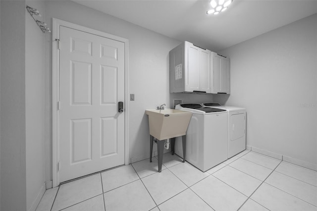 laundry room with separate washer and dryer, baseboards, cabinet space, and light tile patterned floors