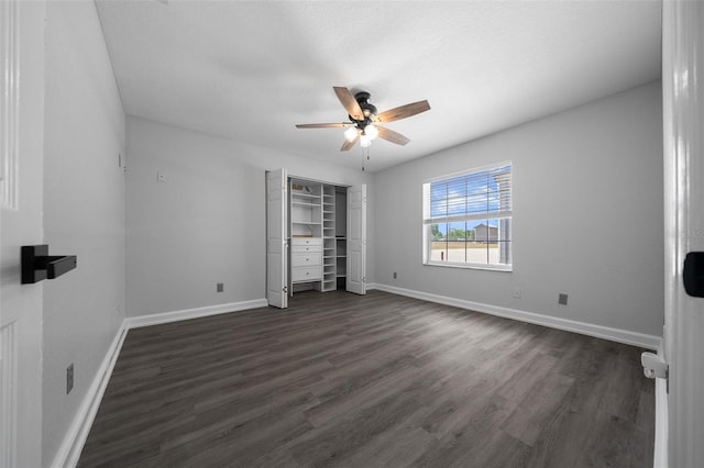 unfurnished bedroom with baseboards, a ceiling fan, and dark wood-style floors