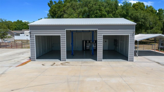 garage featuring fence and a garage