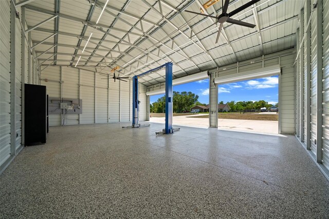garage with a ceiling fan and metal wall