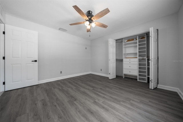 unfurnished bedroom with baseboards, visible vents, and dark wood-style floors